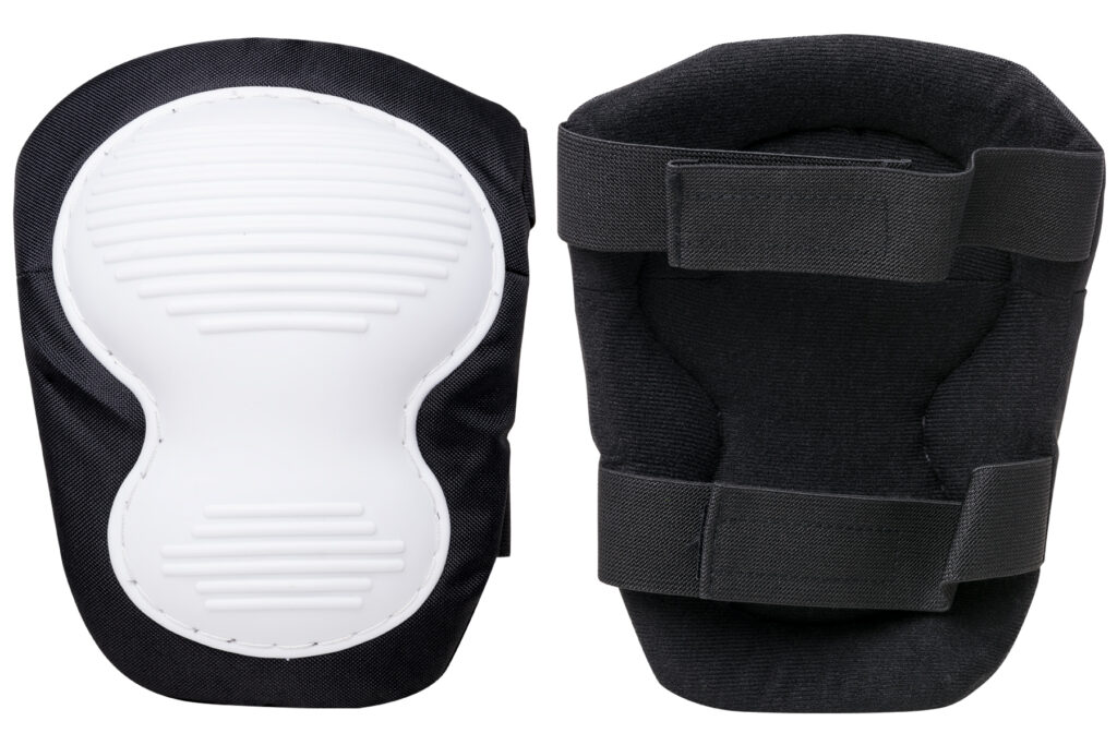 Black knee pads with white ribbed protective caps and adjustable straps.