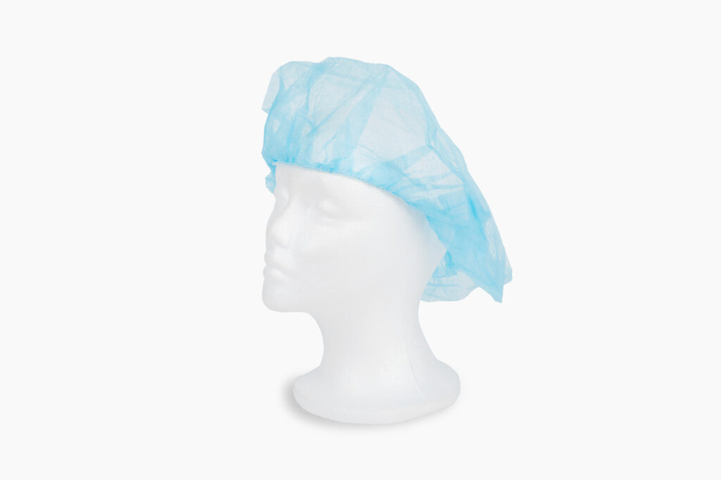 Blue disposable bouffant cap on a white mannequin head.