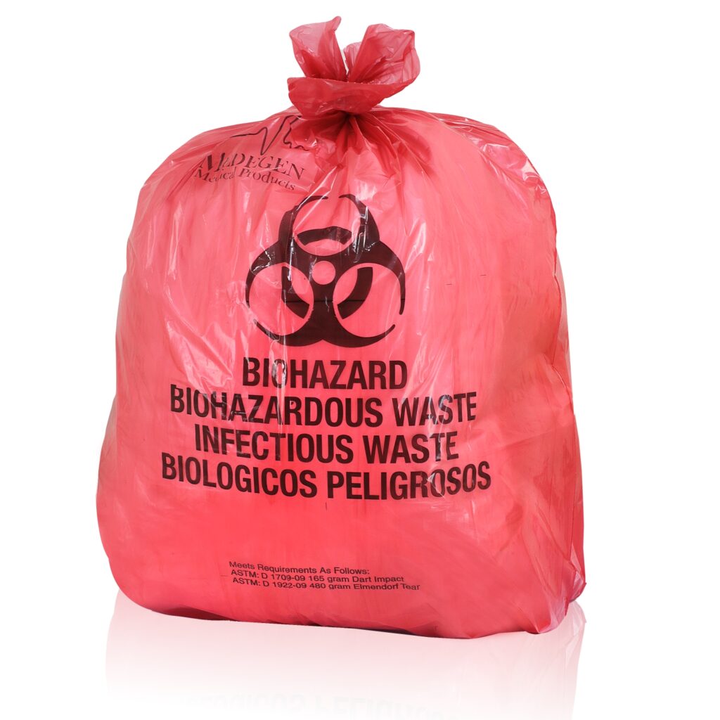 Red biohazard bag with black biohazard symbol and text: "Biohazard, Biohazardous Waste, Infectious Waste, Biologicos Peligrosos."